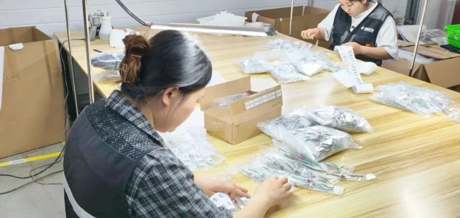 Small items prepared by hand at a packing bench